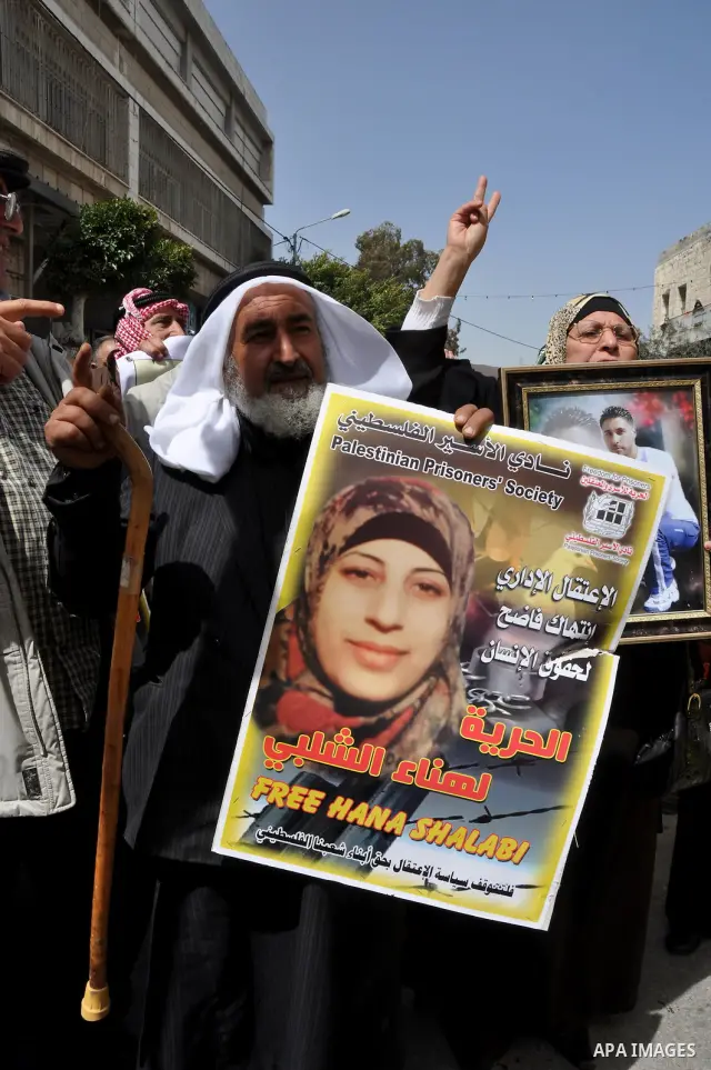 Palestinian women hold portraits of jailed compatriot Hana Shalabi, a female Palestinian prisoner jailed in Israel who has been on hunger strike for 33 days, outside the Red Cross building in the West Bank city of Nablus...