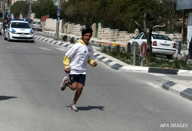 Palestinian youths participating in the Marathon "Jerusalem is the eternal capital of Palestine", which was launched in front of the tomb of President easer President Arafat in Ramallah, West Bank, March 19, 2012 ". Phot...