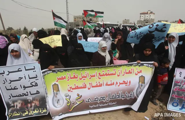 Palestinian women take part in a Hamas rally calling on Egyptian authorities to provide the Gaza Strip with electricity and fuel near the Rafah Border crossing, in the southern Gaza Strip, 20 March 2012. Gazans are repor...