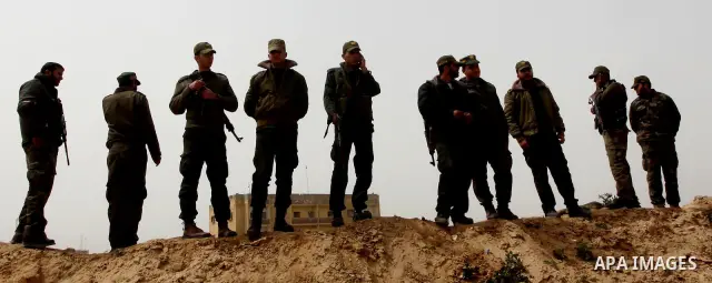 Palestinian security stand guard during a protest by women near the Rafah border crossing with Egypt in the southern Gaza Strip on March 20, 2012 demanding the Egyptian authorities to provide fuel for the power station i...