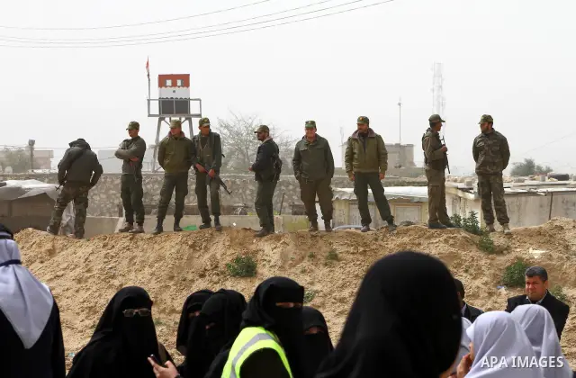 Palestinian security stand guard during a protest by women near the Rafah border crossing with Egypt in the southern Gaza Strip on March 20, 2012 demanding the Egyptian authorities to provide fuel for the power station i...