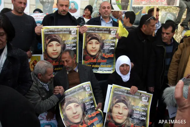 Palestinian women hold portraits of Islamic Jihad supporter Hana Shalabi, a female Palestinian prisoner jailed in Israel who has been on hunger strike for 35 days, during a rally in solidarity with Palestinian prisoners...
