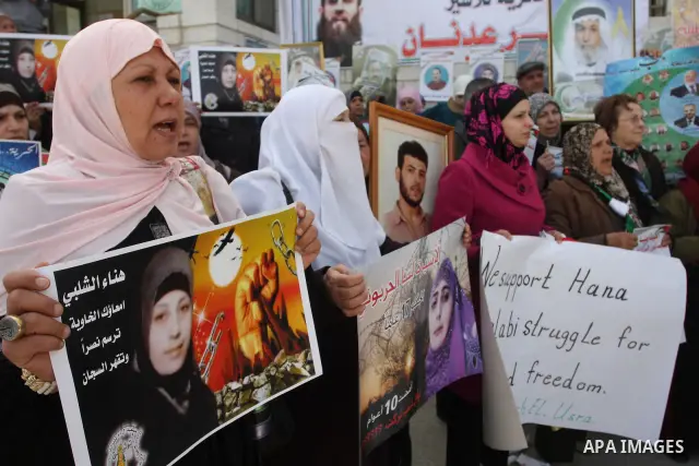 Palestinian women hold portraits of Islamic Jihad supporter Hana Shalabi, a female Palestinian prisoner jailed in Israel who has been on hunger strike for 35 days, during a rally in solidarity with Palestinian prisoners...