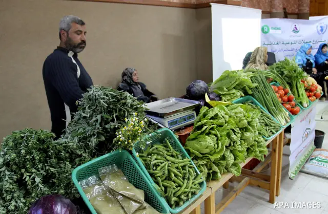 Palestinians attend exhibition for agricultural products in Gaza City on Mar. 22, 2012. to support the Palestinian national products. Photo by Mohammed Asad
