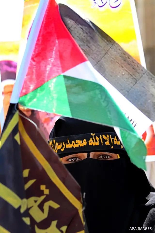 Palestinian women hold portraits of jailed compatriot Hana Shalabi, a female Palestinian prisoner jailed in Israel who has been on hunger strike for 37 days, outside the Red Cross building in Gaza City on Mar. 22, 2012....