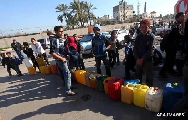 Palestinians wait to fill containers with fuel at a petrol station in Bit Lahia in the northern Gaza Strip March 22, 2012. Palestinians in the Gaza Strip are suffering a crisis of dry petrol pumps and frequent blackouts...
