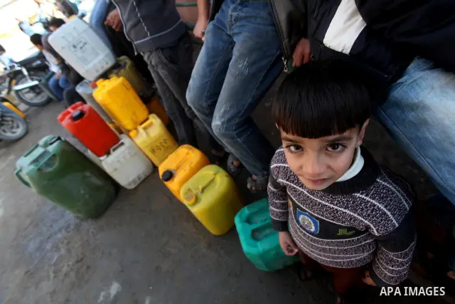 Palestinians wait to fill containers with fuel at a petrol station in Bit Lahia in the northern Gaza Strip March 22, 2012. Palestinians in the Gaza Strip are suffering a crisis of dry petrol pumps and frequent blackouts...