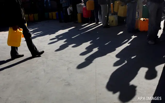 Palestinians wait to fill containers with fuel at a petrol station in Bit Lahia in the northern Gaza Strip March 22, 2012. Palestinians in the Gaza Strip are suffering a crisis of dry petrol pumps and frequent blackouts...