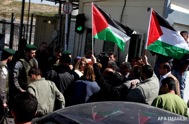 Israeli soldiers stand guard in front of Palestinian protesters demonstrating against the relocation of an Israeli road gate in the village of Beit Iksa in the occupied West Bank between Ramallah and Jerusalem on March 2...
