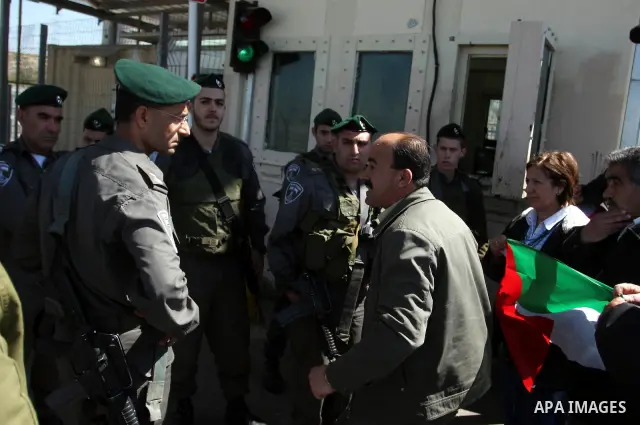 Israeli soldiers stand guard in front of Palestinian protesters demonstrating against the relocation of an Israeli road gate in the village of Beit Iksa in the occupied West Bank between Ramallah and Jerusalem on March 2...