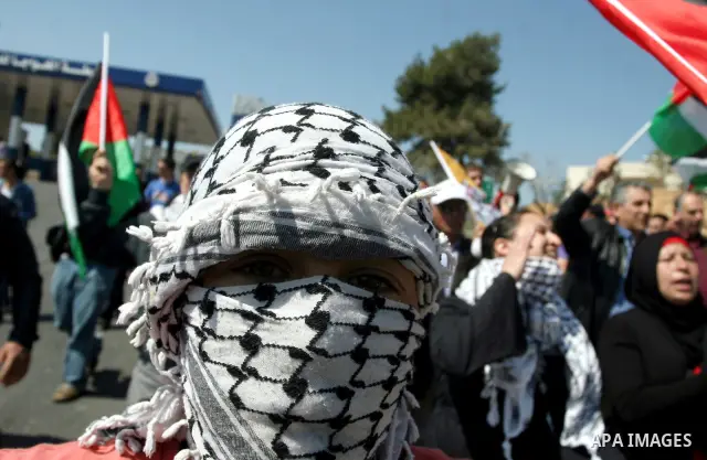 Palestinian protestors run away from tear gas fired by Israeli soldiers during clashes between Israeli soldiers and a group of Palestinian and foreign demonstrators in the West Bank village of Nabi Saleh, near Ramallah o...