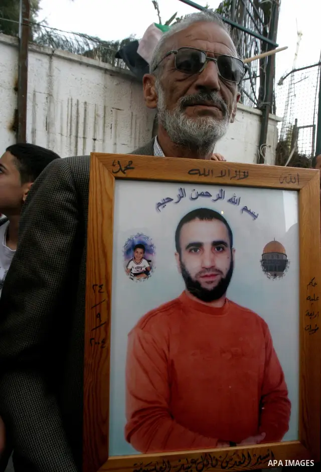 Palestinians hold portraits of relatives detained in Israeli prisons as they protest to demand for their release during a demonstration in support of Hanaa al-Shalabi outside Damascus gate, in the old city of Jerusalem,...