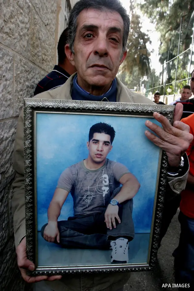 Palestinians hold portraits of relatives detained in Israeli prisons as they protest to demand for their release during a demonstration in support of Hanaa al-Shalabi outside Damascus gate, in the old city of Jerusalem,...