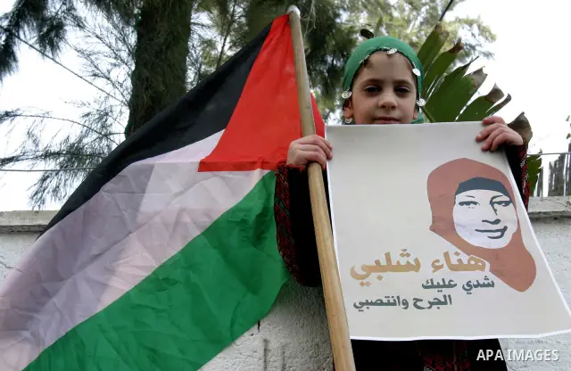 Palestinians hold portraits of relatives detained in Israeli prisons as they protest to demand for their release during a demonstration in support of Hanaa al-Shalabi outside Damascus gate, in the old city of Jerusalem,...
