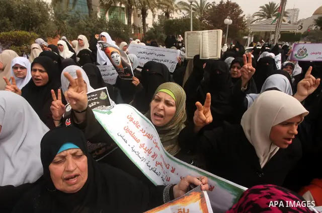 A Palestinian Hamas muslim women next to a poster of Hana Shalaby during a rally at the Palestinian Parliament in Gaza City on, 25 March 2012. Reports state that Hanna Shalabe a Palestinian prisoner in an Israel prison h...