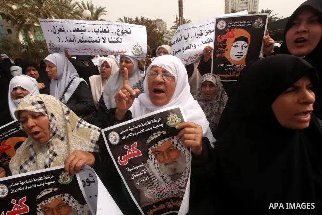 A Palestinian Hamas muslim women next to a poster of Hana Shalaby during a rally at the Palestinian Parliament in Gaza City on, 25 March 2012. Reports state that Hanna Shalabe a Palestinian prisoner in an Israel prison h...