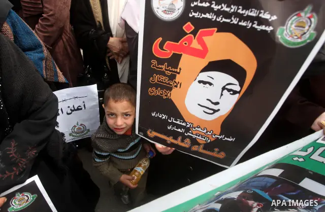 A Palestinian Hamas muslim women next to a poster of Hana Shalaby during a rally at the Palestinian Parliament in Gaza City on, 25 March 2012. Reports state that Hanna Shalabe a Palestinian prisoner in an Israel prison h...