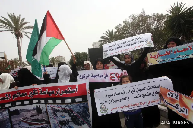 A Palestinian Hamas muslim women next to a poster of Hana Shalaby during a rally at the Palestinian Parliament in Gaza City on, 25 March 2012. Reports state that Hanna Shalabe a Palestinian prisoner in an Israel prison h...