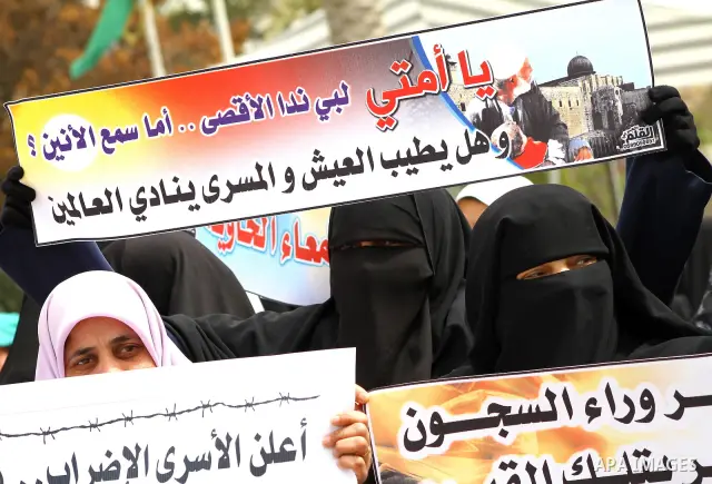 A Palestinian Hamas muslim women next to a poster of Hana Shalaby during a rally at the Palestinian Parliament in Gaza City on, 25 March 2012. Reports state that Hanna Shalabe a Palestinian prisoner in an Israel prison h...