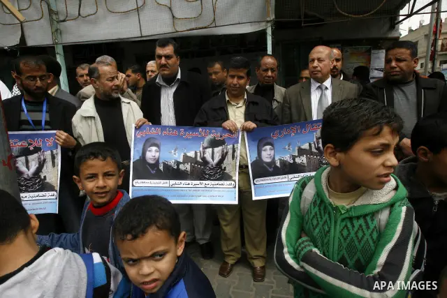 Palestinians hold portraits of jailed compatriot Hana Shalabi, in Rafah on the southern Gaza Strip on, 25 March 2012. Reports state that Hana Shalaby a Palestinian prisoner in an Israel prison has been on a hunger strike...