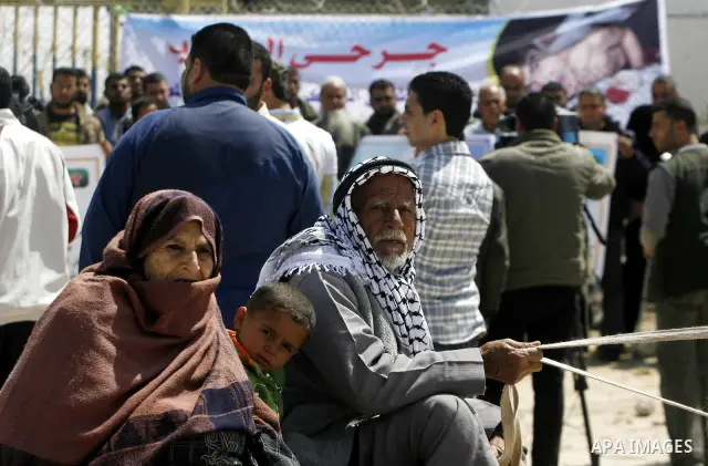 Palestinian demonstrators hold posters during a protest in the Rafah border crossing with Egypt on March 26, 2012, demanding Egypt provide the Gaza Strip with electricity and fuel. The Palestinian energy authority in Gaz...