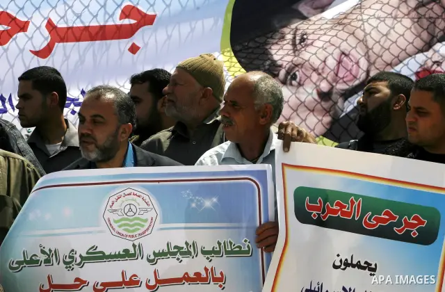 Palestinian demonstrators hold posters during a protest in the Rafah border crossing with Egypt on March 26, 2012, demanding Egypt provide the Gaza Strip with electricity and fuel. The Palestinian energy authority in Gaz...
