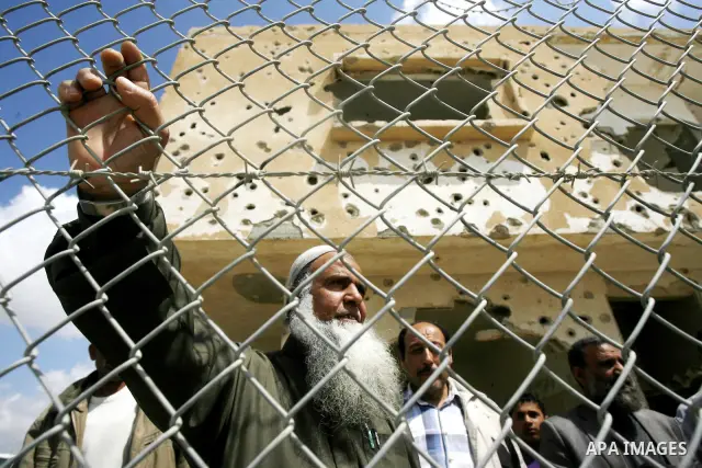 Palestinian demonstrators hold posters during a protest in the Rafah border crossing with Egypt on March 26, 2012, demanding Egypt provide the Gaza Strip with electricity and fuel. The Palestinian energy authority in Gaz...