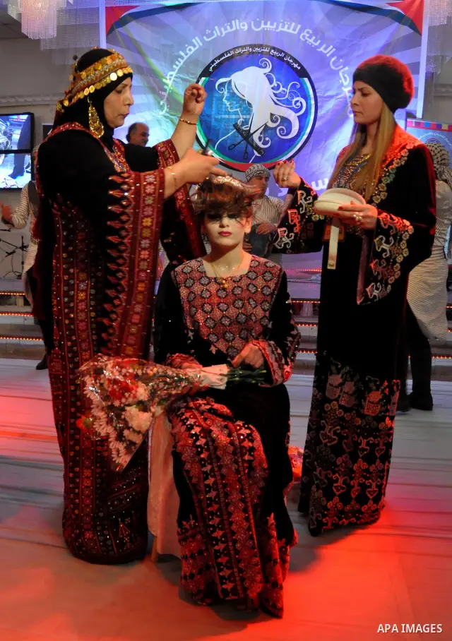 Palestinian models line up on stage during a beauty pageant and hair styling contest in the West Bank city of Tulkarem, Monday, March 26, 2012. Over 100 Palestinians, Israeli Arabs and Golan residents took part in the pa...
