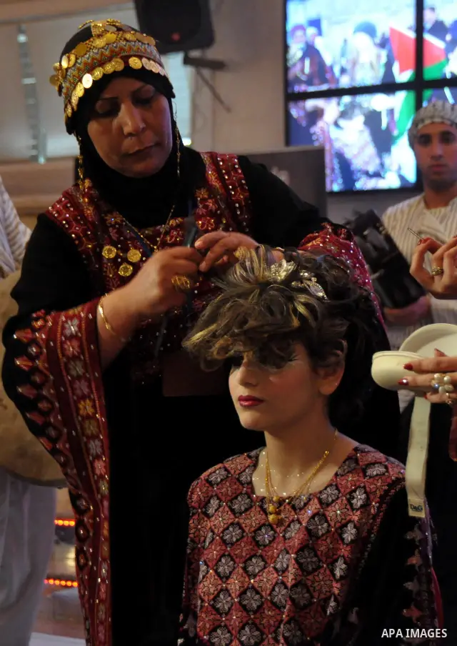 Palestinian models line up on stage during a beauty pageant and hair styling contest in the West Bank city of Tulkarem, Monday, March 26, 2012. Over 100 Palestinians, Israeli Arabs and Golan residents took part in the pa...