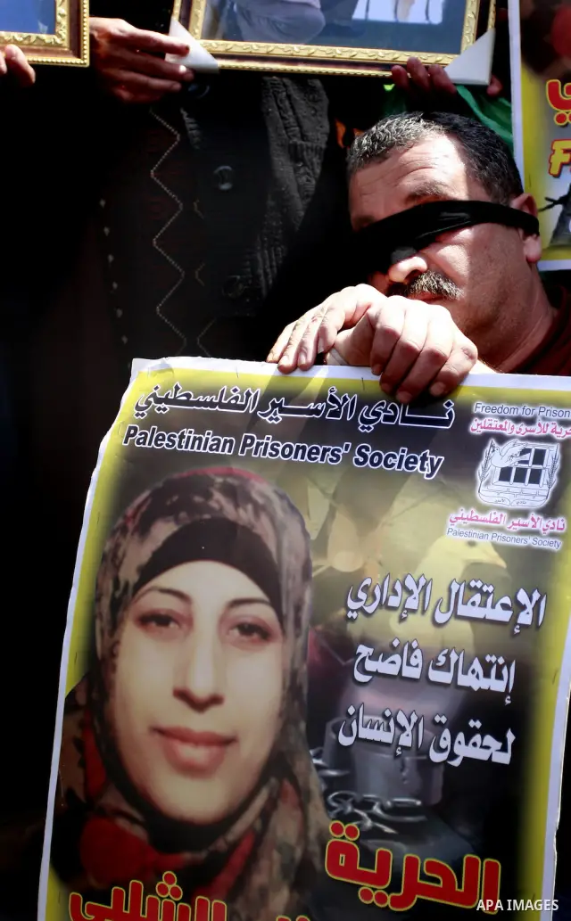 Palestinians hold pictures of prisoners jailed in Israel during a demonstration calling for their release, in the West Bank city of Nablus, Monday, March 26, 2012. Photo by Wagdi Eshtayah