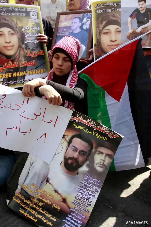 Palestinians hold pictures of prisoners jailed in Israel during a demonstration calling for their release, in the West Bank city of Nablus, Monday, March 26, 2012. Photo by Wagdi Eshtayah