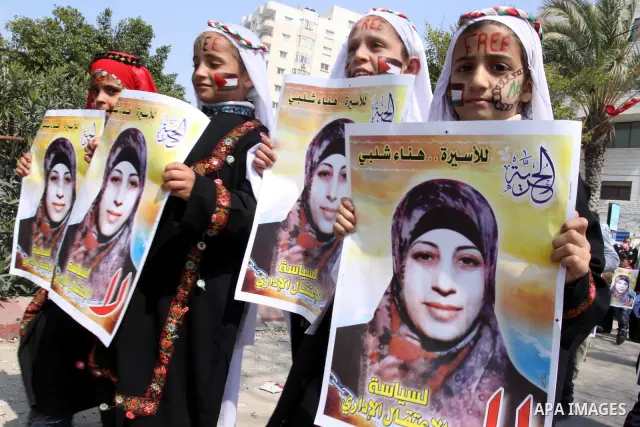 Palestinian children hold portrait of jailed compatriot Hana Shalabi, a female Palestinian prisoner jailed in Israel, outside the Red Cross building in Gaza City on March 27, 2012. Photo by Mohammed Asad