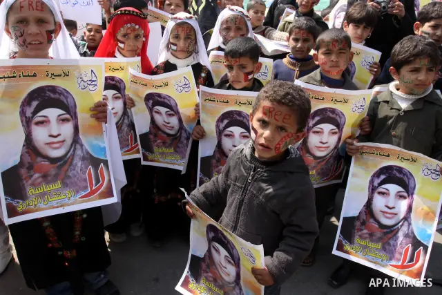 Palestinian children hold portrait of jailed compatriot Hana Shalabi, a female Palestinian prisoner jailed in Israel, outside the Red Cross building in Gaza City on March 27, 2012. Photo by Mohammed Asad