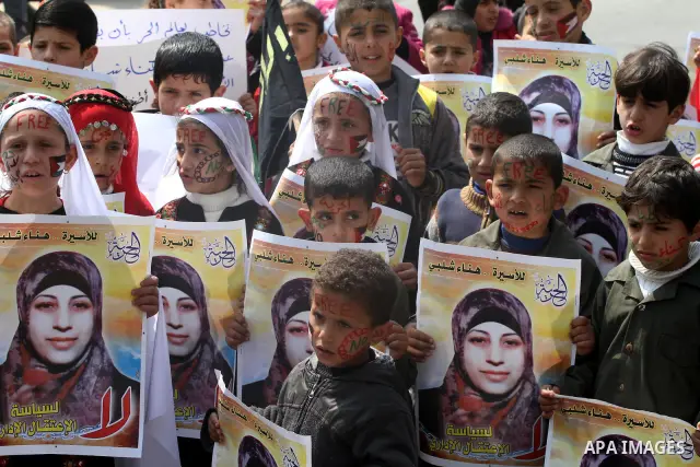 Palestinian children hold portrait of jailed compatriot Hana Shalabi, a female Palestinian prisoner jailed in Israel, outside the Red Cross building in Gaza City on March 27, 2012. Photo by Mohammed Asad