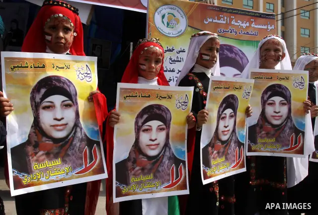 Palestinian children hold portrait of jailed compatriot Hana Shalabi, a female Palestinian prisoner jailed in Israel, outside the Red Cross building in Gaza City on March 27, 2012. Photo by Mohammed Asad