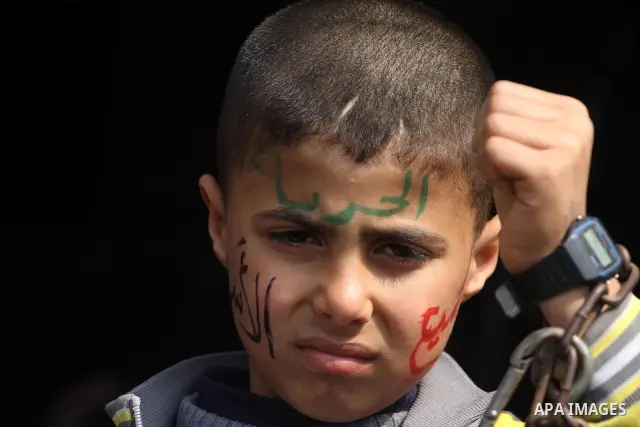 Palestinian children hold portrait of jailed compatriot Hana Shalabi, a female Palestinian prisoner jailed in Israel, outside the Red Cross building in Gaza City on March 27, 2012. Photo by Mohammed Asad