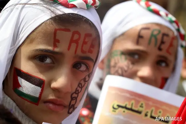 Palestinian children hold portrait of jailed compatriot Hana Shalabi, a female Palestinian prisoner jailed in Israel, outside the Red Cross building in Gaza City on March 27, 2012. Photo by Mohammed Asad