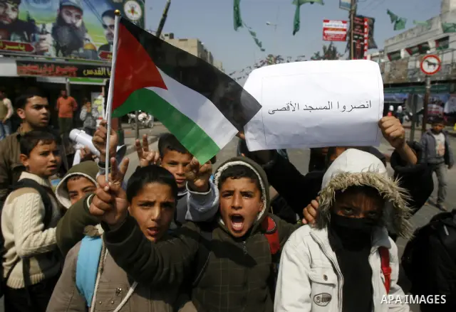 Palestinian children hold logos during protest in Rafah on the southern Gaza Strip on, 28 March 2012 . Gaza is experiencing a major electricity crisis because of a shortage of fuel for the power plant. Photo by Eyad Al B...
