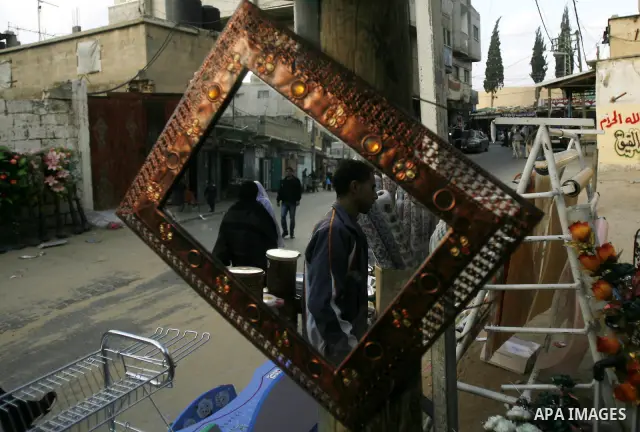 Palestinian man walks near of protest in Rafah on the southern Gaza Strip on, 28 March 2012. . Gaza is experiencing a major electricity crisis because of a shortage of fuel for the power plant. Photo by Eyad Al Baba