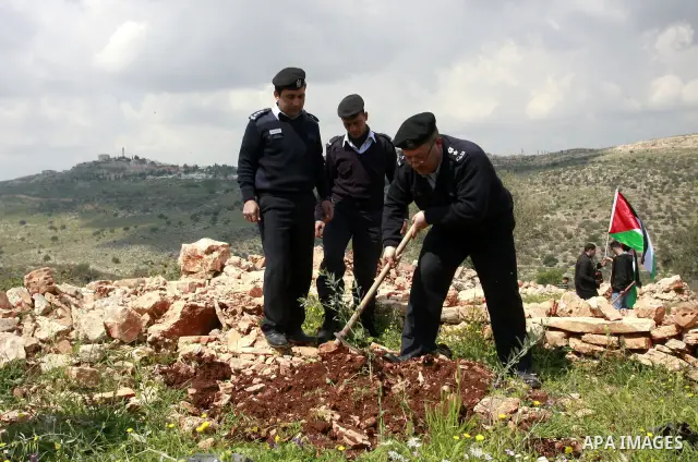Palestinian security officers plant trees during an event marking Land Day ,in the village of Kufr Diek , West Bank, Thursday , March 29, 2011. Land Day commemorates the killing of six Arab citizens of Israel by the Isra...