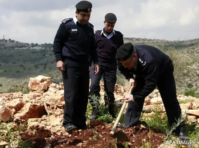 Palestinian security officers plant trees during an event marking Land Day ,in the village of Kufr Diek , West Bank, Thursday , March 29, 2011. Land Day commemorates the killing of six Arab citizens of Israel by the Isra...