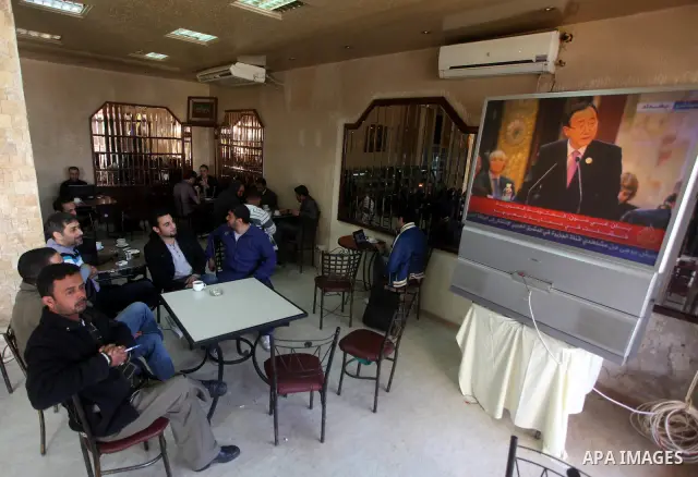 Palestinians watch TV. during a meeting of Arab foreign ministers in the framework of the Arab summit in Baghdad, Iraq, March 29, 2012. Photo by Ashraf Amra