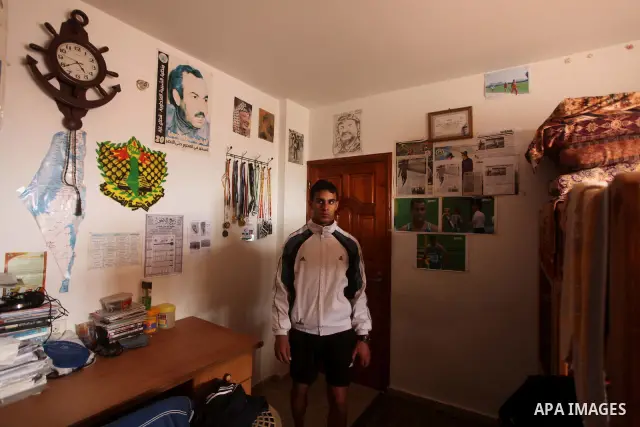 Palestinian runner Bahaa al-Farra, who has been selected to represent Palestine at the London Olympics in July - August 2012 during a break at his house in Gaza City on March 29, 2012. Farra will be one of a four-strong...