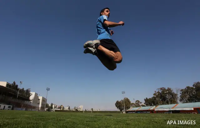 Palestinian runner Bahaa al-Farra, who has been selected to represent Palestine at the London Olympics in July - August 2012 during training at the al-Yarmouk soccer stadium in Gaza City on March 29, 2012. Farra will be...