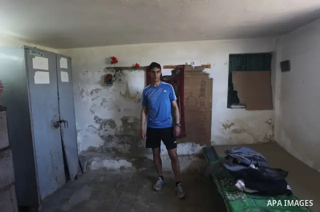 Palestinian runner Bahaa al-Farra, who has been selected to represent Palestine at the London Olympics in July - August 2012 during a break at his house in Gaza City on March 29, 2012. Farra will be one of a four-strong...