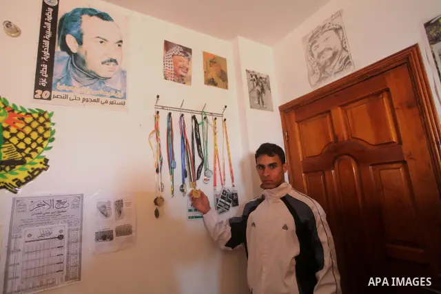 Palestinian runner Bahaa al-Farra, who has been selected to represent Palestine at the London Olympics in July - August 2012 during a break at his house in Gaza City on March 29, 2012. Farra will be one of a four-strong...
