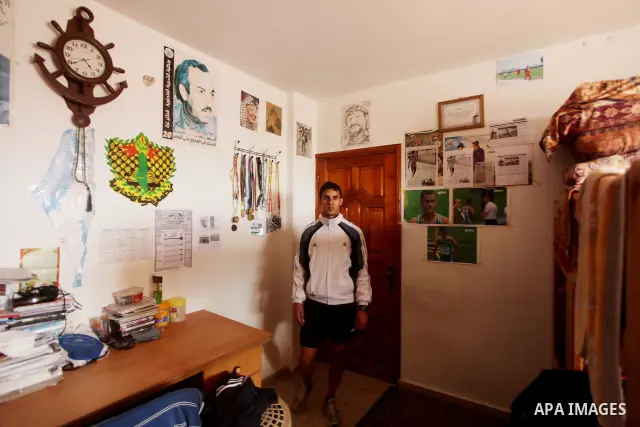 Palestinian runner Bahaa al-Farra, who has been selected to represent Palestine at the London Olympics in July - August 2012 during a break at his house in Gaza City on March 29, 2012. Farra will be one of a four-strong...