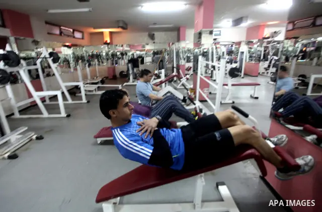 Gaza runner Bahaa al-Farra is reflected in a mirror as he trains at a gym in Gaza City March 29, 2012. The 19-year-old trains for three hours a day in Gaza's Yarmouk soccer stadium, along the dusty streets and on the bea...