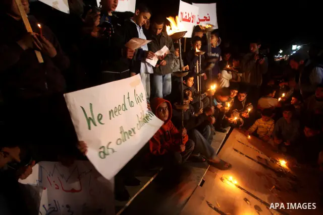 Palestinian children hold candles during a protest calling for power in Gaza City, on March 29, 2012. The Red Cross said on March, 29 it would ship emergency supplies of fuel to help alleviate the Gaza Strip's worsening...