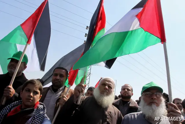 Palestinian protesters take part in a protest marking Land Day, near the border between Israel and the northern Gaza Strip March 30, 2012. Israeli security forces fired rubber bullets, tear gas and stun grenades to break...